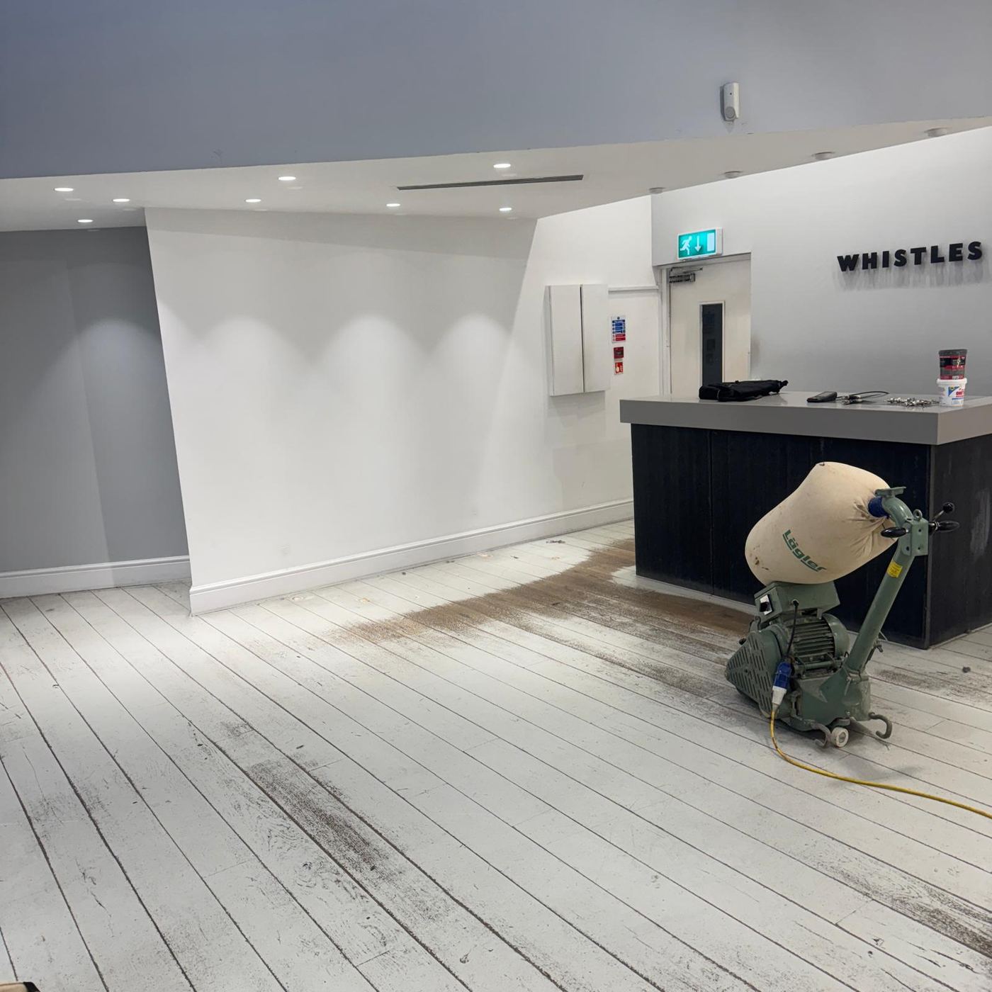 Tomasz sanding a floor with a professional machine